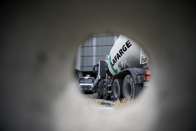 © Reuters. A concrete mixing truck is seen through a hole in a wall at Lafarge concrete production plant in Pantin