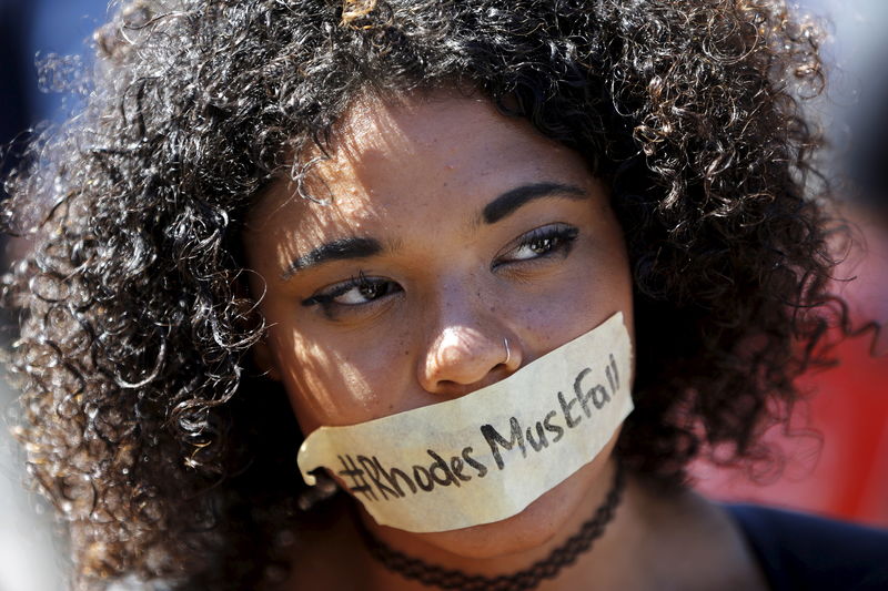 © Reuters. Student wears a sticker calling for the removal of a statue of Cecil John Rhodes from the campus of the University of Cape Town 