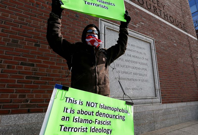 © Reuters. Jose Briceno of Cambridge holds a sign in front of the Moakley federal courthouse in Boston