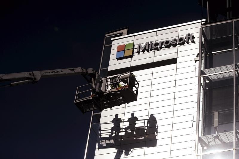 © Reuters. Workers install the logo of U.S. technology giant Microsoft on the wall of Nokia's former headquarters in Espoo