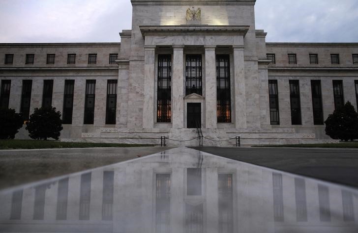 © Reuters. The facade of the U.S. Federal Reserve building is reflected on wet marble during the early morning hours in Washington