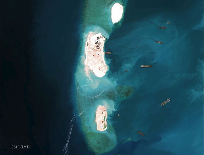 © Reuters. Satellite image of dredgers reinforcing a site being constructed on the westernmost part of Mischief Reef