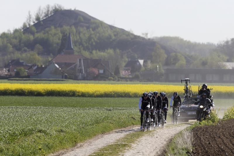 © Reuters. Treck team riders make their way along a cobble-stoned section as they train for the upcoming Paris-Roubaix cycling race near a slag heap in Haveluy