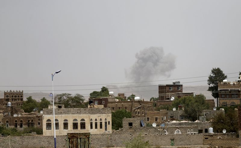 © Reuters. Smoke rises from a military post after it was hit by an air strike in Sanaa