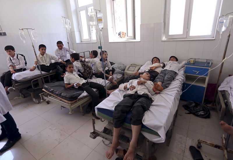 © Reuters. Afghan schoolboys receive treatment at a hospital after falling ill in Herat Province