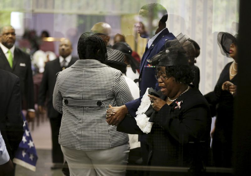 © Reuters. Judy Scott weeps as she is escorted in for the funeral of her son, Walter Scott, at W.O.R.D. Ministries Christian Center