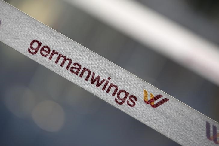 © Reuters. A barrier tape of German airline Lufthansa's low-cost carrier Germanwings is pictured at a closed gate of Berlin Tegel airport