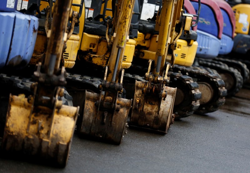 © Reuters. Excavators are parked in machine yard in Tokyo