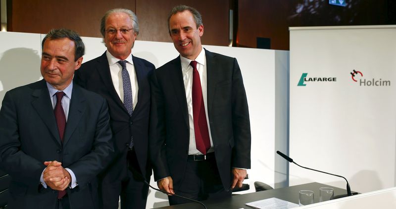 © Reuters. Current CEO of Lafarge Lafont, Reitzle, who will be chairman of the new merged entity LafargeHolcim, and upcoming CEO Olsen pose for the media after a news conference in Zurich