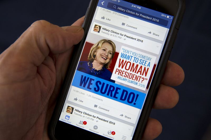 © Reuters. A mobile phone shows a Facebook page of campaign propaganda to promote Hillary Clinton as president in 2016, in this photo illustration taken April 13