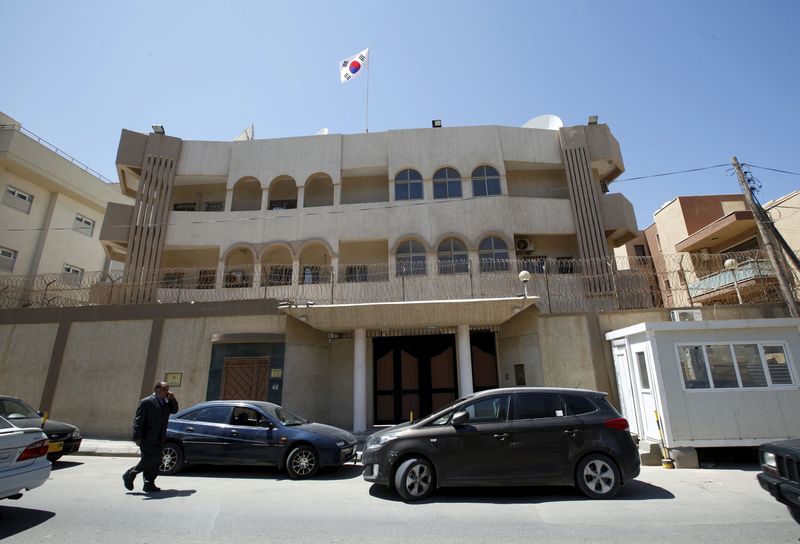 © Reuters. Man walks past the South Korean embassy after it was attacked by gunmen in Tripoli 