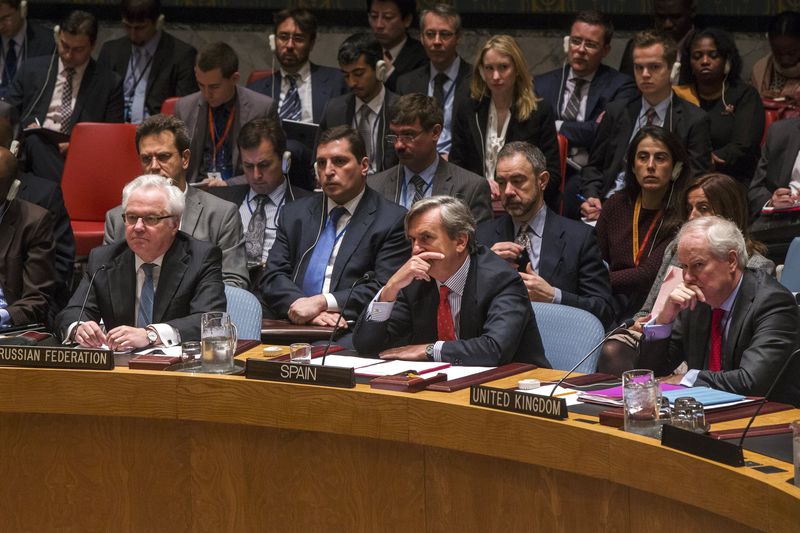 © Reuters. Russian ambassador to United Nations Vitaly Churkin sits with representatives from Spain and the United Kingdom after a vote in the United Nations Security Council attempting to halt the escalating conflict in Yemen in New York 