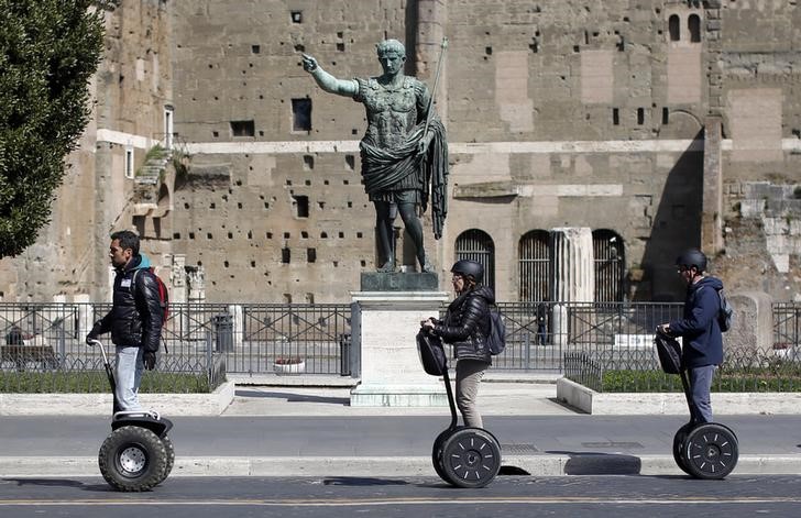 © Reuters. Tourists ride on Segways in downtown Rome