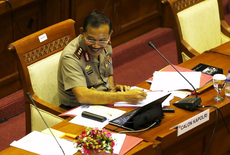 © Reuters. Indonesia police chief candidate Badrodin Haiti talks to parliament members during a fit-and-proper test at parliament building in Jakarta