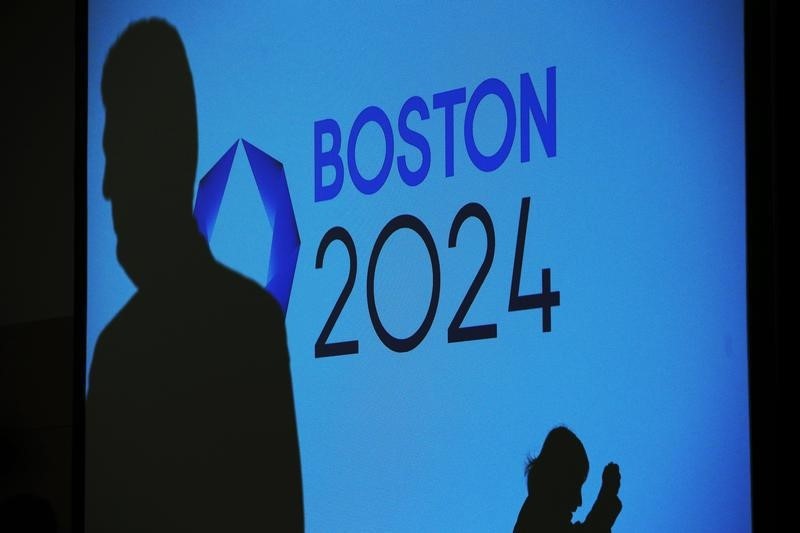 © Reuters. People cast shadows on a video display before a news conference explaining Boston's bid to host the 2024 Summer Olympics in Boston