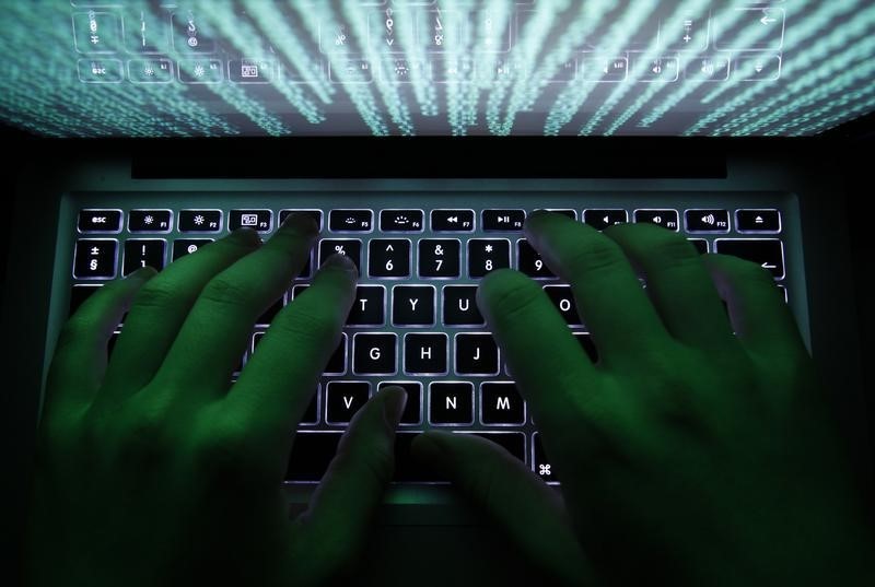 © Reuters. Illustration file picture shows a man typing on a computer keyboard in Warsaw