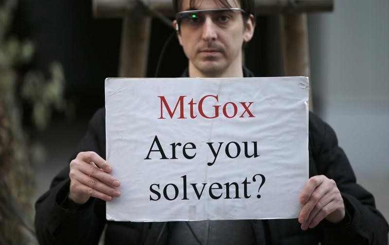 © Reuters. Protester holds a placard during a demonstration against Mt. Gox in Tokyo