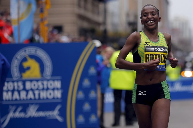 © Reuters. Rotich of Kenya crosses the finish line to win the women's division of the 119th Boston Marathon in Boston