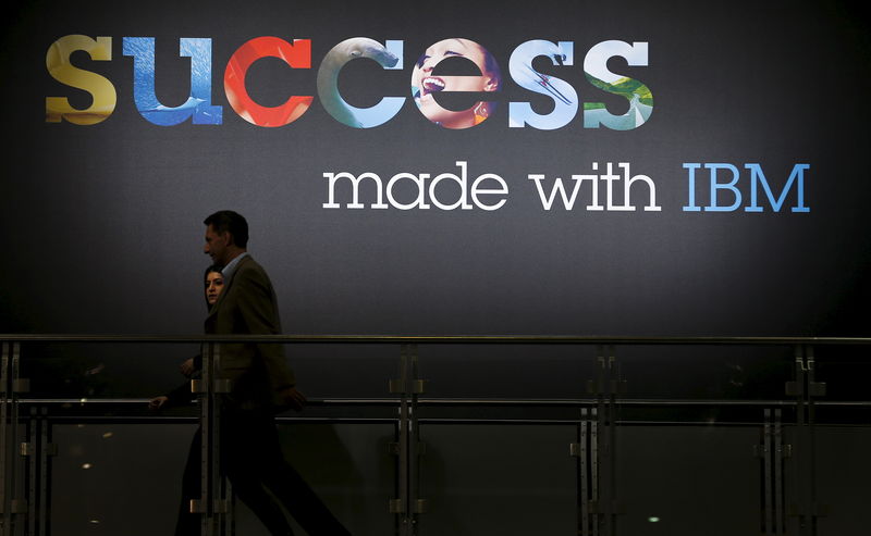 © Reuters. File photo of people walking past sign at the booth of IBM at the CeBIT trade fair in Hanover