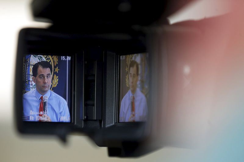 © Reuters. Potential Republican 2016 presidential candidate Wisconsin Governor Scott Walker is seen in a television viewfinder while speaking to local activists and elected officials in Derry