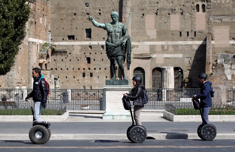 © Reuters. Tourists ride on Segways in downtown Rome