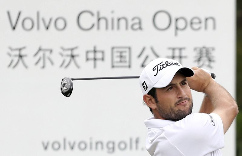 © Reuters. Alexander Levy of France tees off during the first day of the China Open at Tomson Golf Club in Pudong, Shanghai