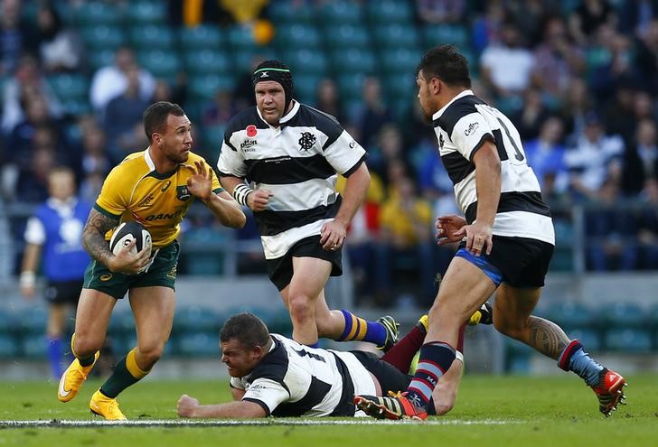 © Reuters. Australia's Quade Cooper is challenged by Barbarians' Matt Stevens and Angus Ta'avao during their international rugby union friendly match at Twickenham