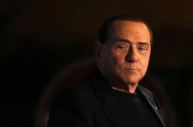 © Reuters. Former Prime Minister Silvio Berlusconi looks on during a speech from the stage in downtown Rome