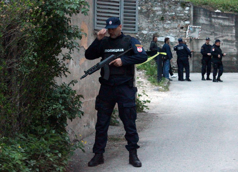 © Reuters. Members of special police take position in front of attacked police station in Zvornik