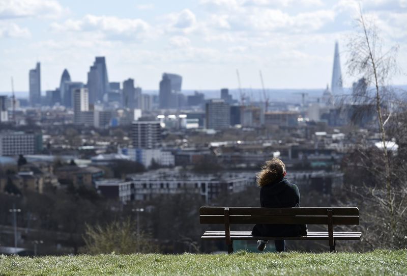 © Reuters. A woman looks towards the City of London financial district from Parliament Hill in north London