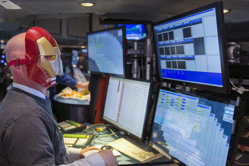 © Reuters. A trader wears an Iron Man mask on the floor of the New York Stock Exchange on the day that cast members of the film Avengers: Age of Ultron will visit the exchange in New York