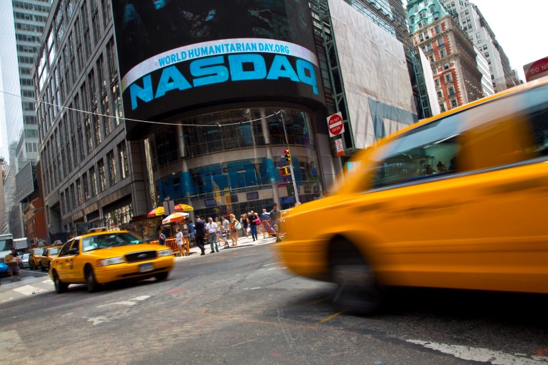 © Reuters. Taxi cabs drive  past the Nasdaq MarketSite in New York's Times Square