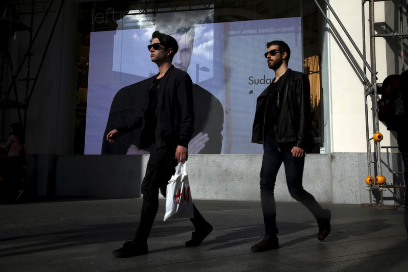 © Reuters. A man a shopping bag at a commercial district in Madrid