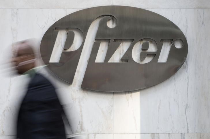 © Reuters. A man walks past Pfizer's world headquarters in New York