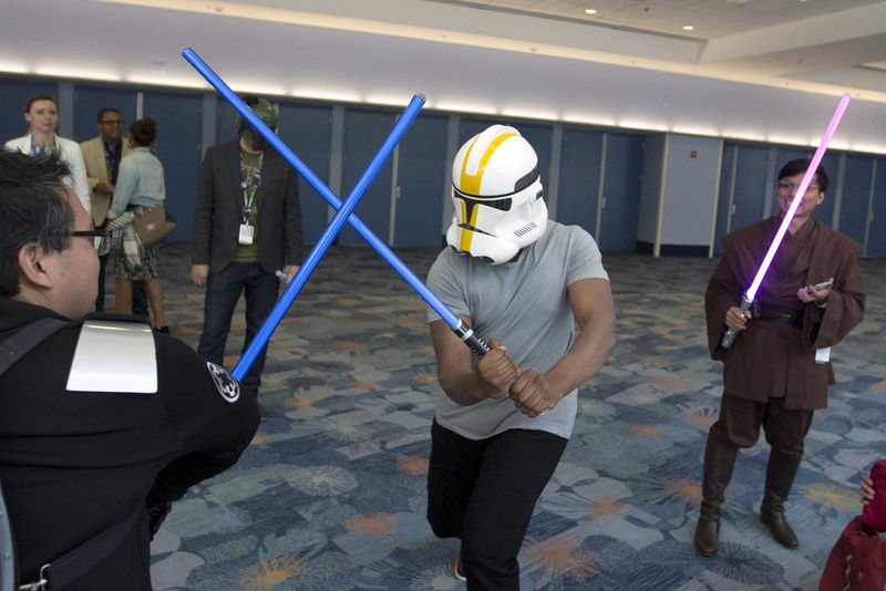 © Reuters. Star Wars: The Force Awakens cast member John Boyega disguises his identity with a helmet and engages unknowing fans in a light saber fight scene at the Star Wars Celebration convention in Anaheim