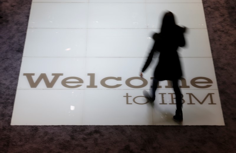 © Reuters. A woman walks over a welcoming sign at the booth of IBM at the CeBIT trade fair in Hanover