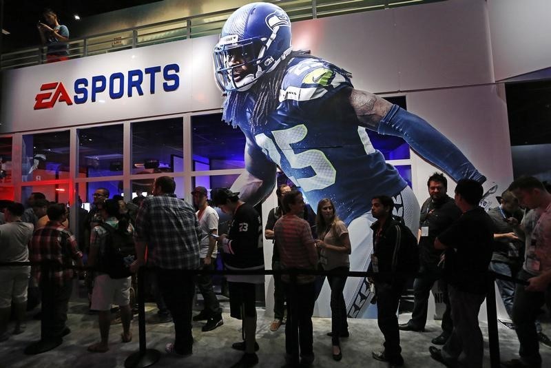© Reuters. People wait in-line under "Madden NFL 15" billboard with an image of NFL player Sherman at the Electronic Arts booth during the 2014 Electronic Entertainment Expo, known as E3, in Los Angeles