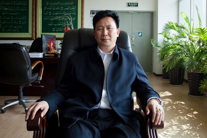 © Reuters. Sipu Enterprises Group Chief Executive Zhang Long poses at his office in Kunming