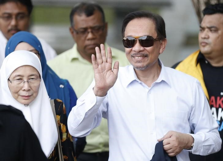 © Reuters. Malaysia's opposition leader Anwar Ibrahim with his wife Wan Azizah arrive for his final appeal against a conviction for sodomy in Putrajaya