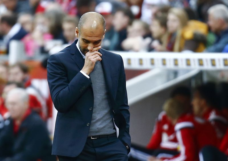 © Reuters. Bayern Munich's coach Guardiola reacts after Bayer Leverkusen scored a goal during their German first division Bundesliga soccer match in Leverkusen