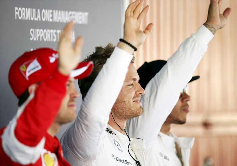 © Reuters. Mercedes F1 driver Rosberg celebrates his pole position next to team mate Hamilton and Ferrari driver Vettel after the qualifying session of the Spanish Grand Prix at the Circuit de Barcelona-Catalunya racetrack in Montmelo