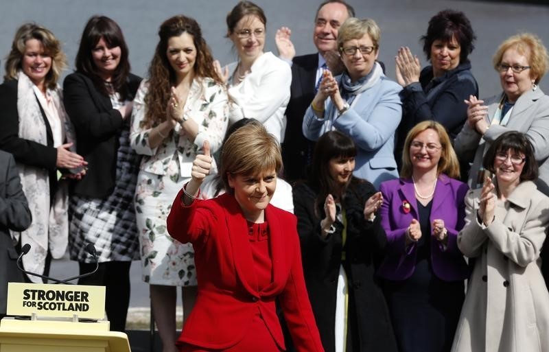 © Reuters. Scotland's First Minister, and leader of the Scottish National Party, Nicola Sturgeon poses for a photograph with the newly elected SNP MP's in South Queensferry, Edinburgh Scotland