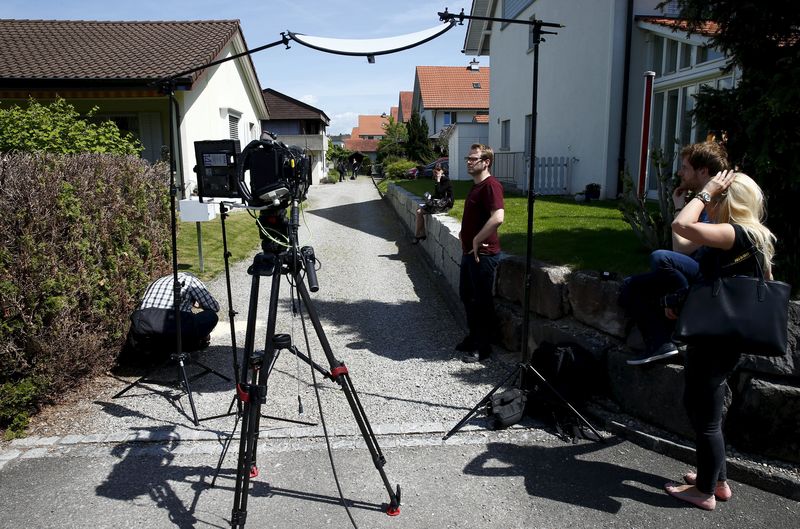 © Reuters. TV crews perpare for a statement in front of a house in Wuerenlingen