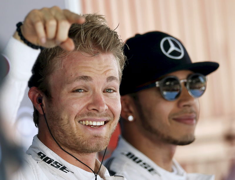 © Reuters. Mercedes F1 driver Nico Rosberg of Germany celebrates his pole position, while team mate Lewis Hamilton of Britain smiles after the qualifying session of the Spanish Grand Prix at the Circuit de Barcelona-Catalunya racetrack