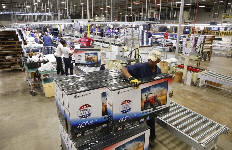 © Reuters. A worker stacks boxes of TV sets before moving them to the warehouse at Element Electronics