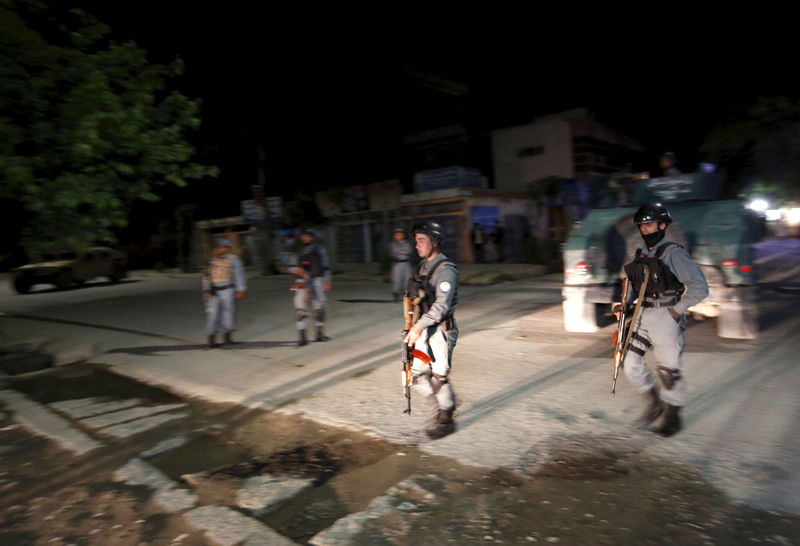 © Reuters. Afghan policemen stand guard at the site of an attack in Kabul, Afghanistan 