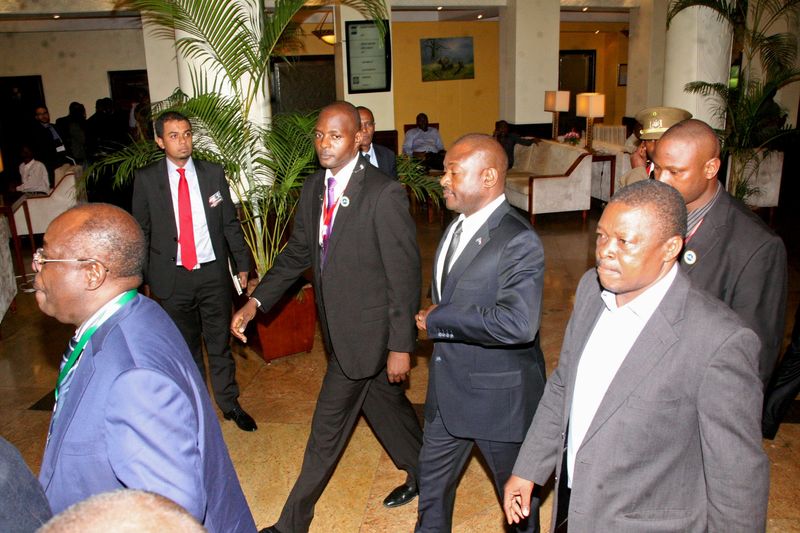 © Reuters. Nkurunziza is escorted on his way to the Julius Nyerere International Airport in Tanzania