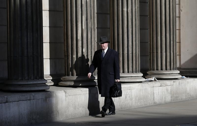 © Reuters. A man walks past the Bank of England in London