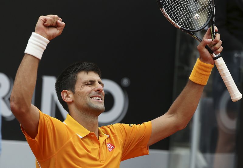 © Reuters. Djokovic of Serbia celebrates after winning his semi-final match against Ferrer of Spain at the Rome Open tennis tournament in Rome