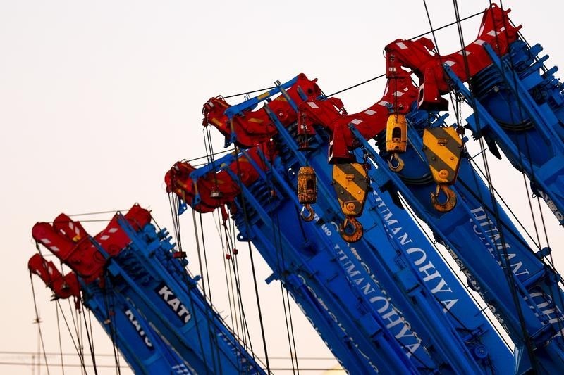 © Reuters. Cranes are parked in a company compound in Tokyo